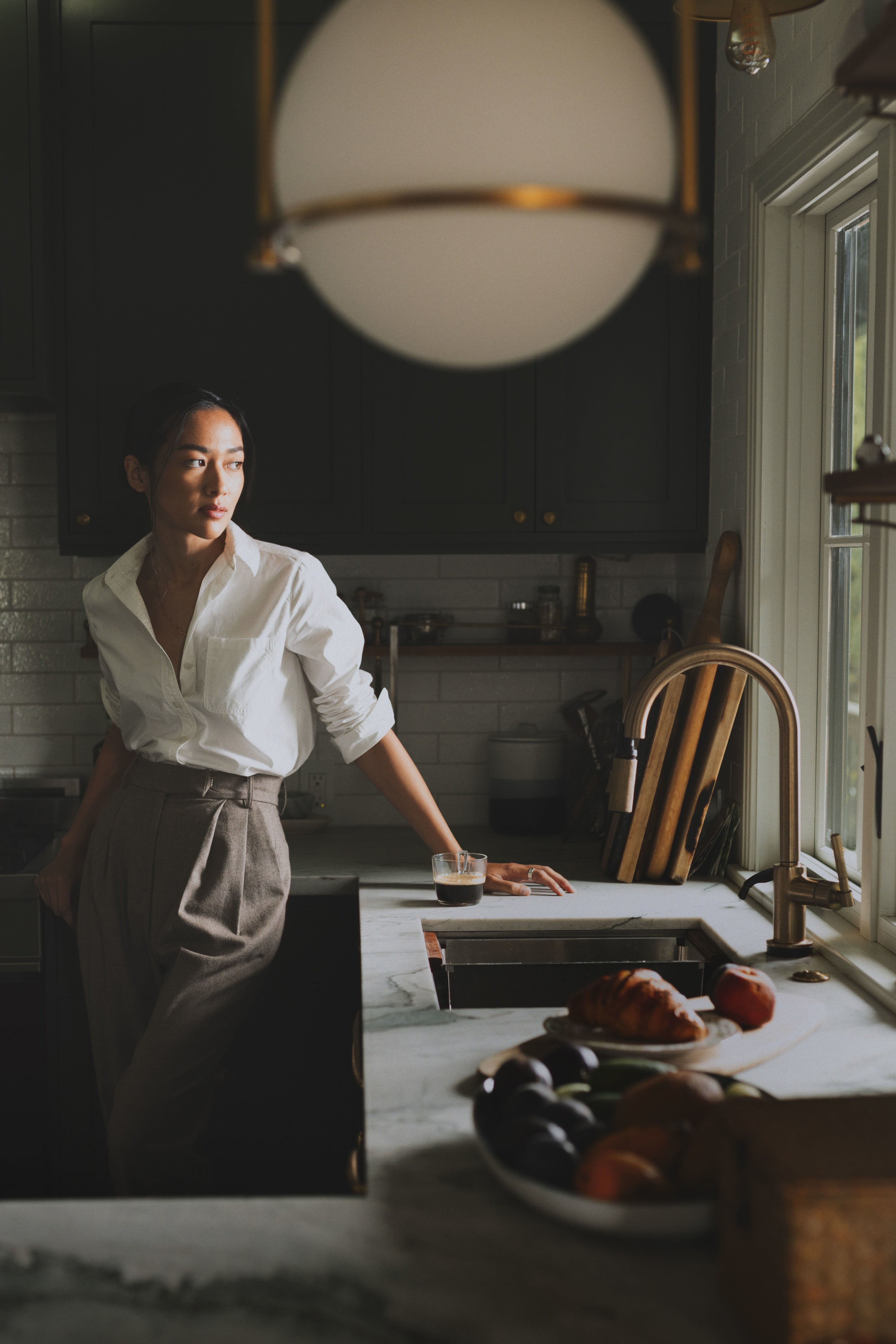 Alana in her kitchen in the morning wearing Trial Trouser in Coffee