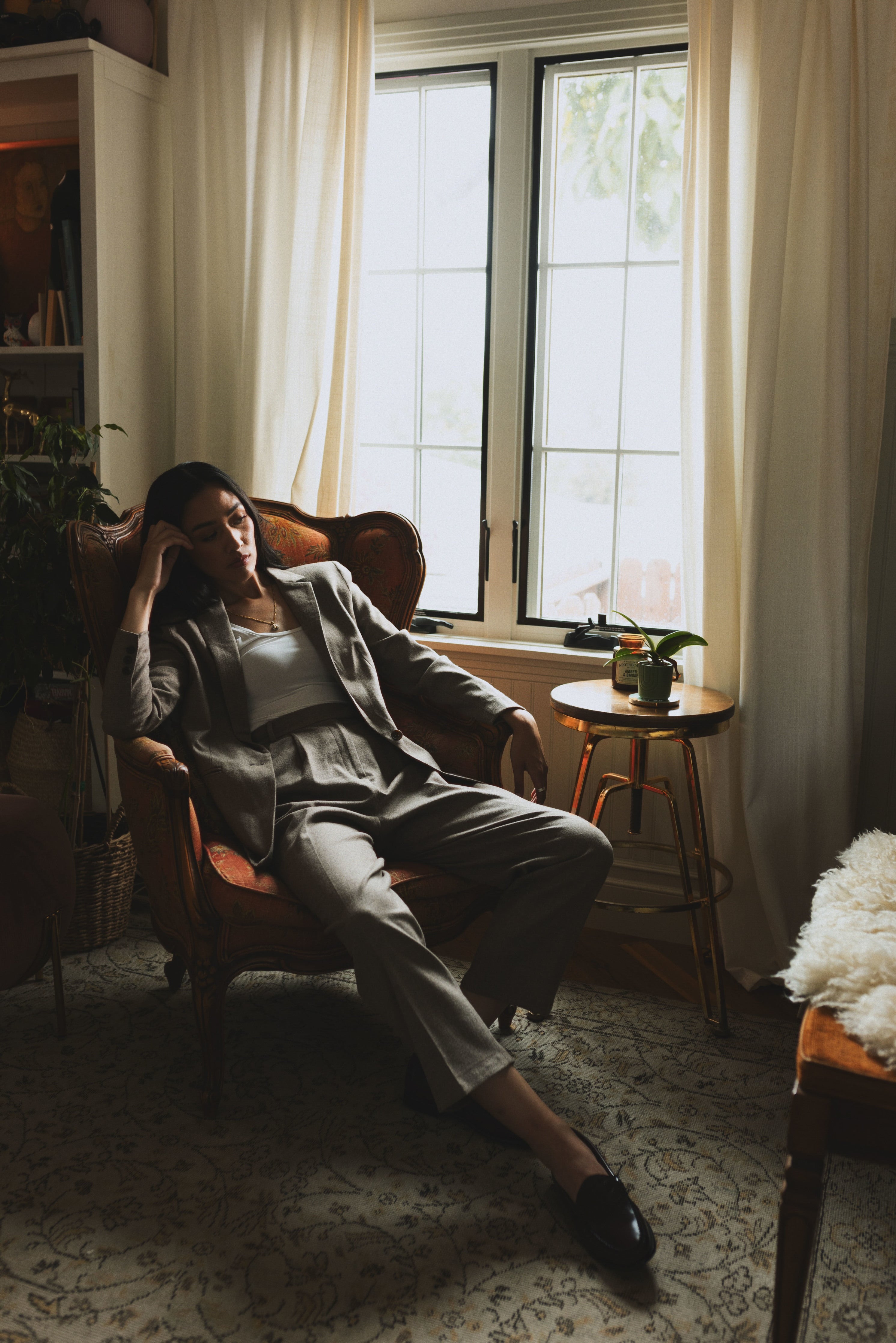 Alana in Court Jacket and Trial Trouser in Coffee on lounge chair