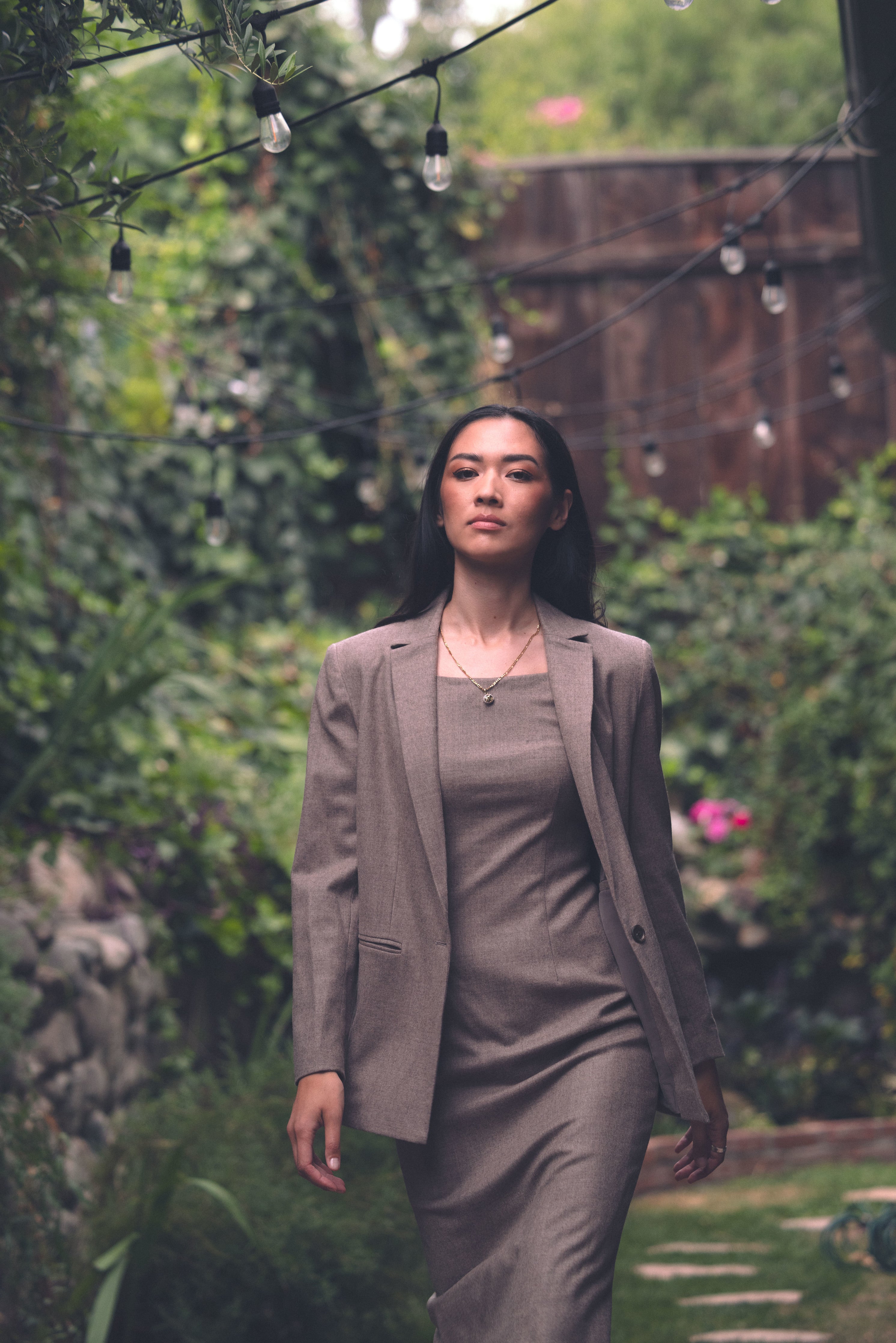 Front view of Alana in garden in 90's Midi and Court Jacket in Coffee 